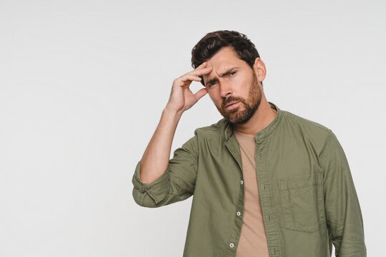 Portrait, man and pain with headache in studio of stress, vertigo and burnout pressure. Mockup space, male person and migraine for fatigue, muscle tension and brain fog of mistake on white background