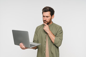 Studio shot of a thoughtful man freelancer IT Programmer using laptop research for creative software with project development looking confused against a white background. Error problems bug brain fog