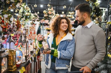 Happy couple shopping for festive christmas decorations