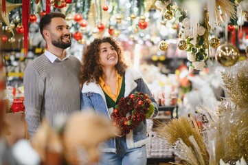 Couple enjoying christmas shopping for holiday decorations