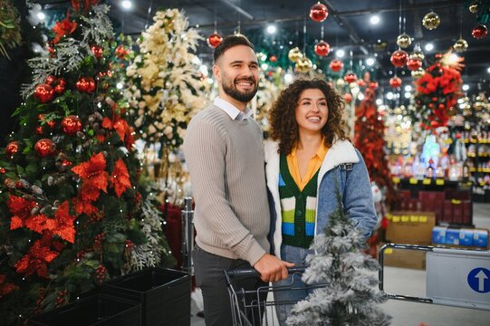 Happy couple shopping christmas decorations in store