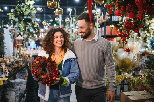 Happy couple shopping christmas decorations at store