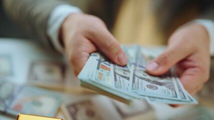 Businessman's hands counting a large sum of us dollars over a table with more cash and gold bars, representing wealth, earnings, investment success, and financial prosperity - Powered by Adobe
