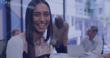 Smiling Asian woman leading discussion in conference room, with laptop notebooks world map overlay