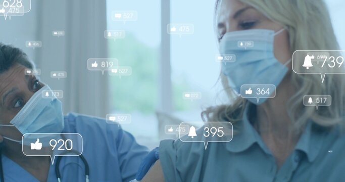Administering nurse wearing scrubs injecting vaccine in clinic, with syringe and social media icons - Powered by Adobe