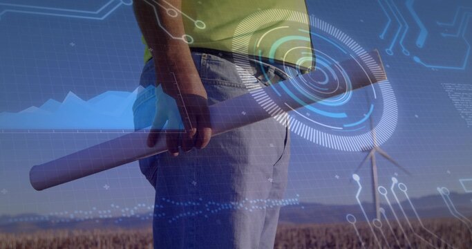Standing engineer holding blueprint in farm field at sunset, with HUD overlays and wind turbine