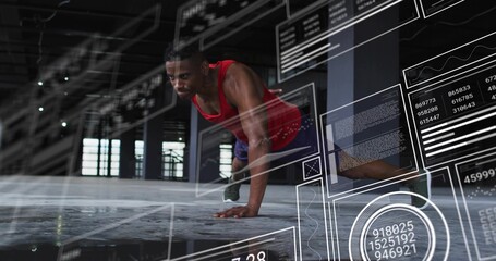 Performing push-ups man wearing red tank top and shorts in warehouse, with AR charts, copy space