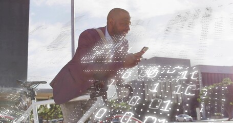 Leaning on white bicycle, man wearing burgundy blazer on city street, viewing smartphone data