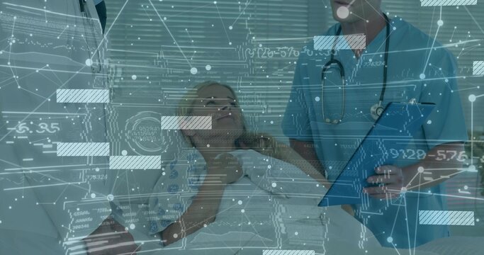 Healthcare provider in blue scrubs checking patient on hospital bed with digital overlay graphics