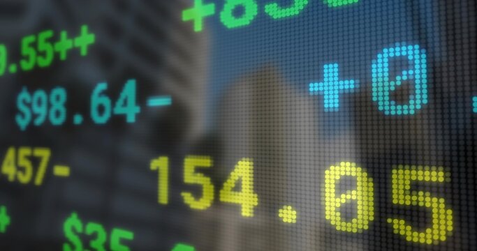 Displaying LED ticker streaming dollar sign plus minus symbols and pixel grid in financial district