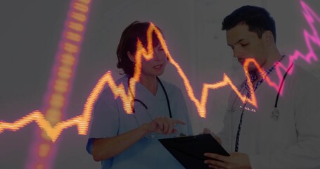 Reviewing clipboard, blue-scrub nurse and white-coat doctor in clinic with stethoscopes, ECG graph