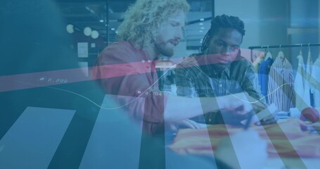 Male colleagues examining swatches on tablet and smartphone in studio, chart overlay garment rack