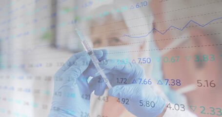 Showing blue-gloved hands holding filled syringe in clinic with masked seniors and financial data