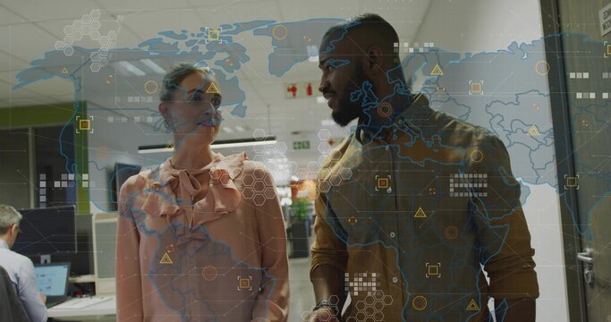 Walking two colleagues in office attire navigating office hallway, with digital world map overlay