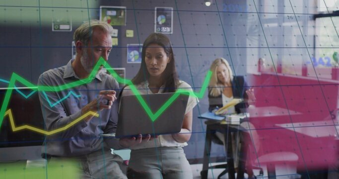 Examining laptop data two colleagues wearing business attire in conference room, with sticky notes