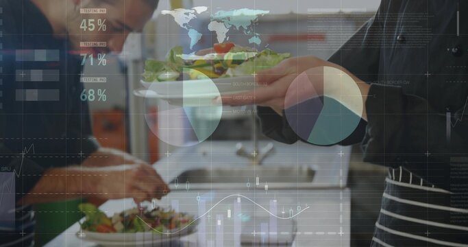 Working chefs wearing aprons plating fresh salads on plates in restaurant kitchen, data overlays