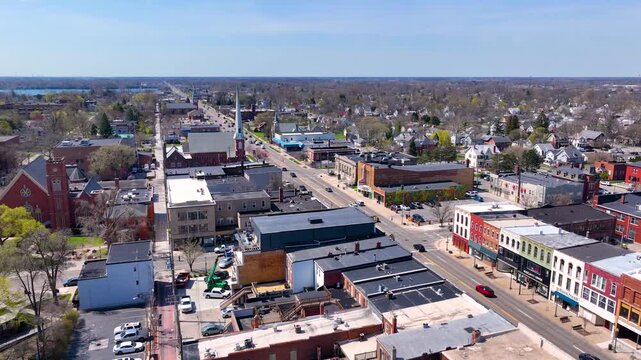 Martin Luther King bridge over River Raisin and Historic residential buildings aerial view on E Elm Avenue in historic downtown Monroe, Michigan MI, USA. 