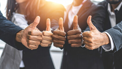 Diverse business team showing thumbs up for success