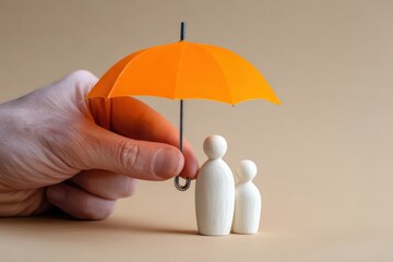 Hand holding orange umbrella providing care and security for small wooden figures representing a family, symbolizing protection and insurance