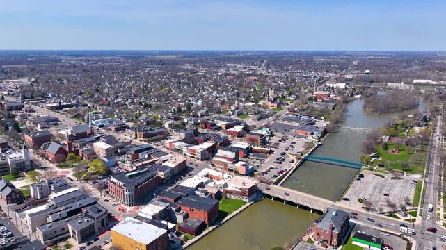 Martin Luther King bridge over River Raisin and Historic residential buildings aerial view on E Elm Avenue in historic downtown Monroe, Michigan MI, USA. 