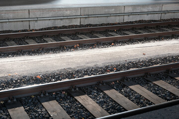 The train tracks are made of wood and rocks
