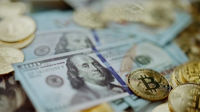 Golden bitcoin cryptocurrency coins lying on top of one hundred dollar us banknotes, symbolizing the intersection of traditional fiat money and modern digital currency in the global economy - Powered by Adobe