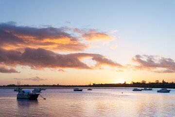 Dramatic sunrise and colourful sky in landscape over harbour