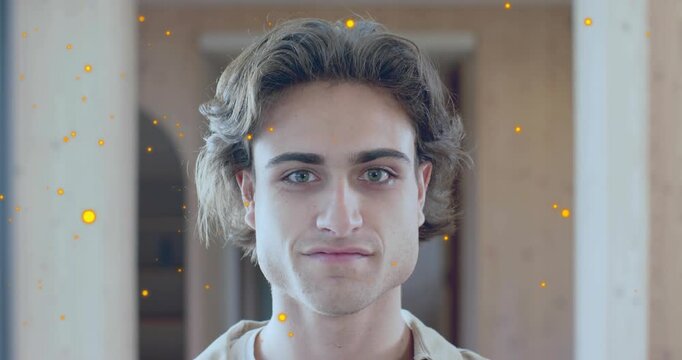 man facing camera while particles drifting, initiating focus pulling and smile appearing tech demo