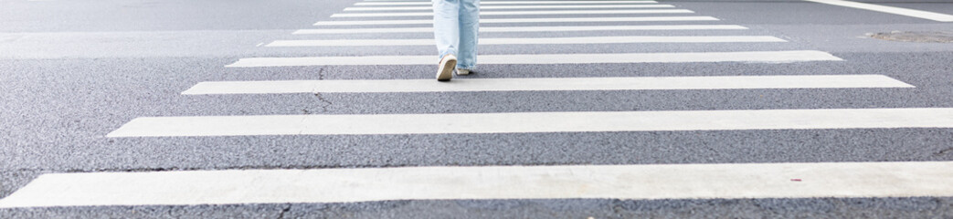 Person walking on pedestrian crosswalk on city street