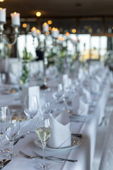 Elegant dining setup with fine tableware and candles in a restaurant during evening hours