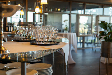 Elegant dining setup in a modern restaurant with sparkling glassware and a serene atmosphere in the late afternoon