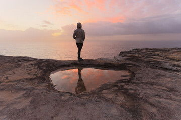 Woman morning ccoastal walk watching sunrise