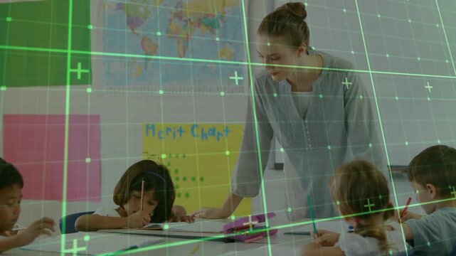 Teacher leaning on table guiding pencil work in education while boy raising hand for assistance