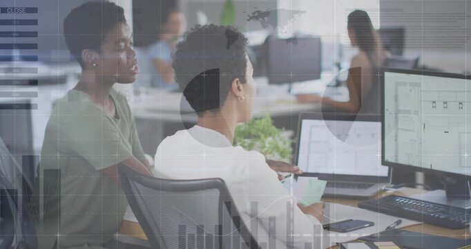 Seated designer receiving color swatch and tapping layout with coworker guiding UI refinement