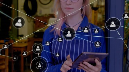 Bicycle repair shop manager in apron tapping tablet and swiping for visualizing network overlay - Powered by Adobe