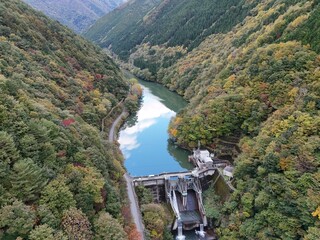 A beautiful mountain valley with a river running through it. The river is surrounded by trees and...