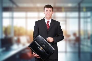 Happy professional businessman posing in office