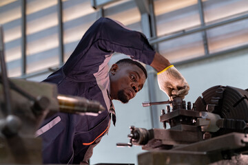 Engineer closely inspecting precision components on a metal lathe machine. Focus, technical expertise, industrial engineering, mechanical work, and manufacturing process.