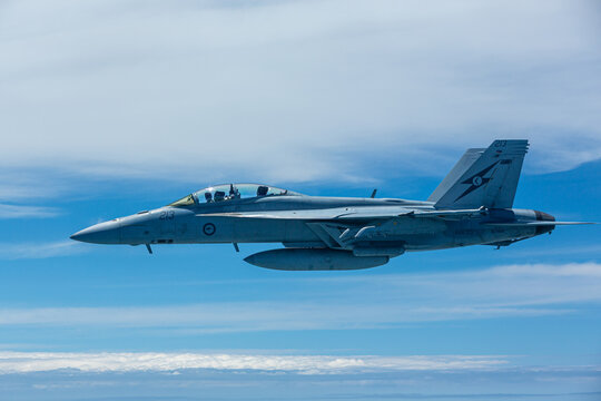Close up side view of an Australian RAAF FA18 Super Hornet flying at altitude.