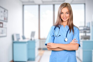 Portrait of happy nurse or doctor in hospital at work.
