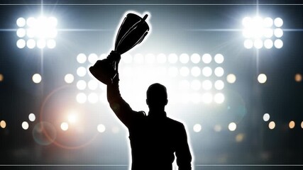 Silhouette of a person holding a trophy aloft against a backdrop of stadium lights
