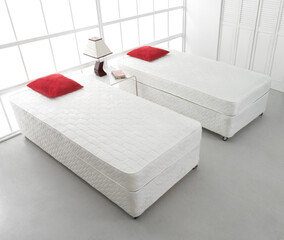 White double bed with red pillows in modern bedroom