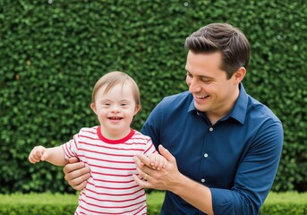 Happy father holding and supporting his smiling young child with down syndrome outdoors.