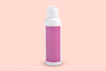 Shower gel or shampoo in clean white plastic cosmetics bottle isolated on pink background.