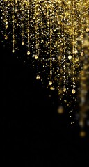 Golden glitter and teardrop beads cascade from above on black background.