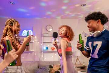 Group of diverse Generation Z friends enjoying a party in a cozy house. 