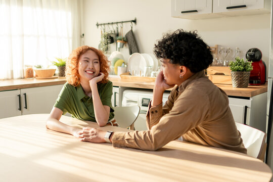 Diverse young adult couple spending quality time together in house.