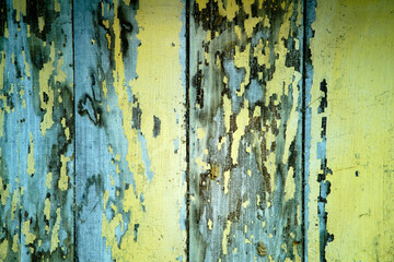 Weathered Wood Planks with Yellow and Blue Peeling Paint Texture