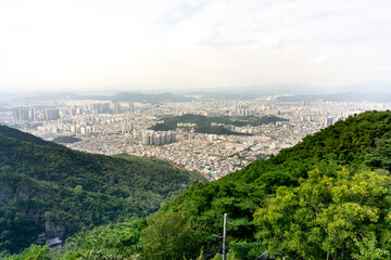 Obraz premium Daegu City, South Korea, September 26, 2025: Daegu Whole City View from Apsan Observatory after using Apsan Cable Car for City Panorama View with Apartments, Buildings, Mountains 대구 도시 전경 앞산 전망대 케이블카 