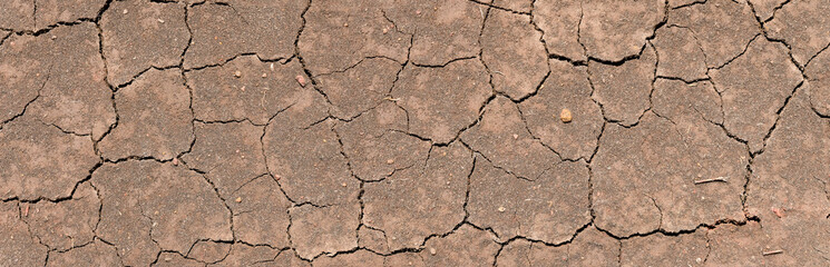 Wall texture soil dry crack pattern of drought lack of water of nature brown old broken background.